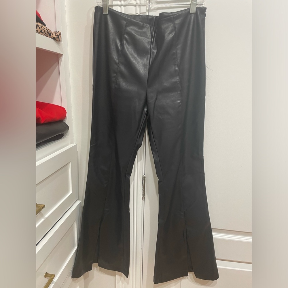 Vegan leather pants. Never worn.  Small pull at the seem (see photo). Size large